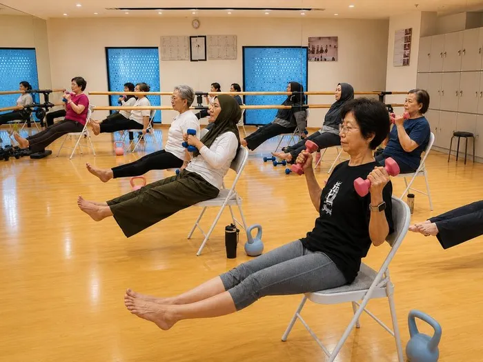 Balance class — seated exercises with dumbbells